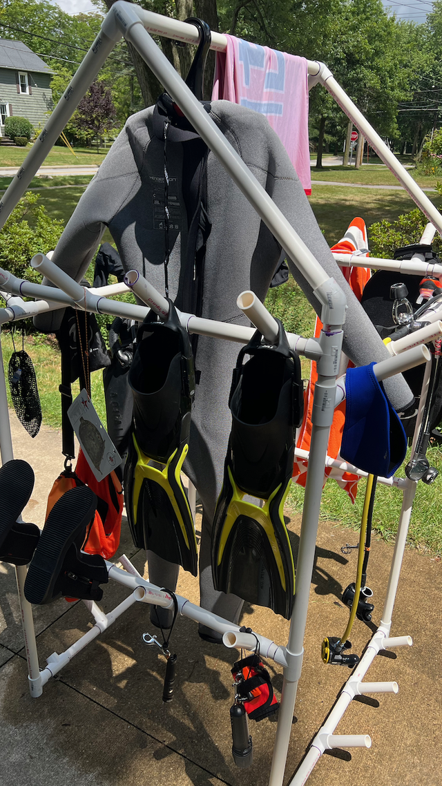 The scuba rack, with various gear hung on it, on a different day, from the opposite side